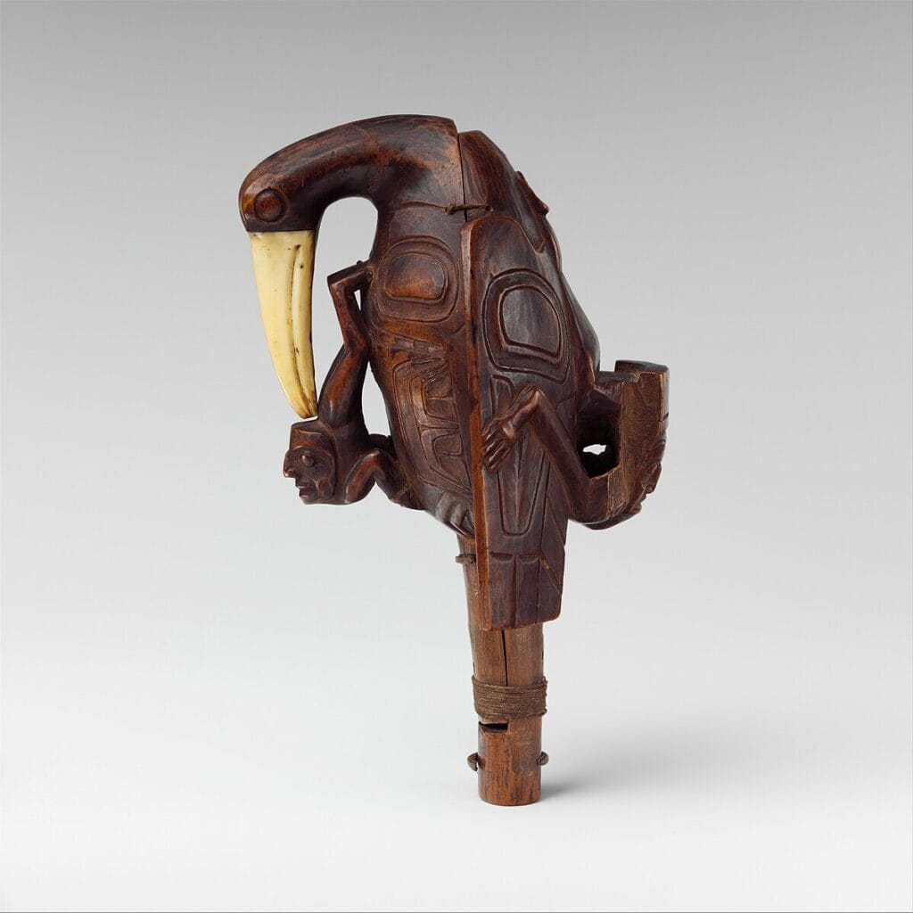 Haida raven rattle with reclining human figure, symbol of Raven's creative, trickster role.