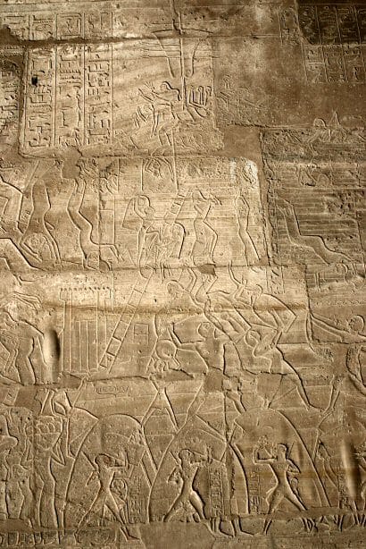 Relief from the Ramesseum showing the Siege of Dapur with Egyptian soldiers climbing scaling ladders under archery cover.