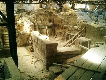 Excavation at Akrotiri showing ash-covered streets and doorways preserved by the eruption.