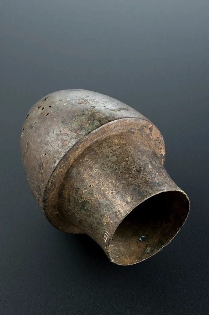 Bronze cupping cup photographed against a neutral background.