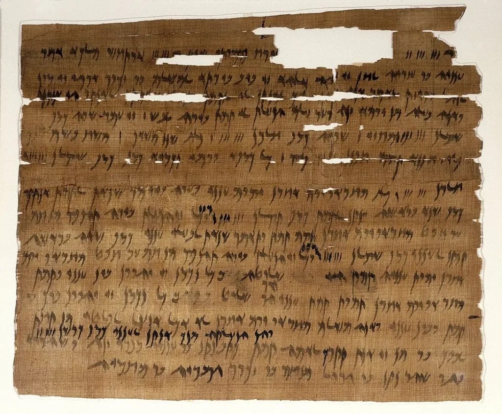 Aramaic papyrus marriage document mounted under glass, with clear lines of ink.
