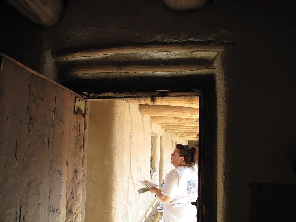 Interior wooden door fitted with fur-style weatherstripping at Bent’s Old Fort