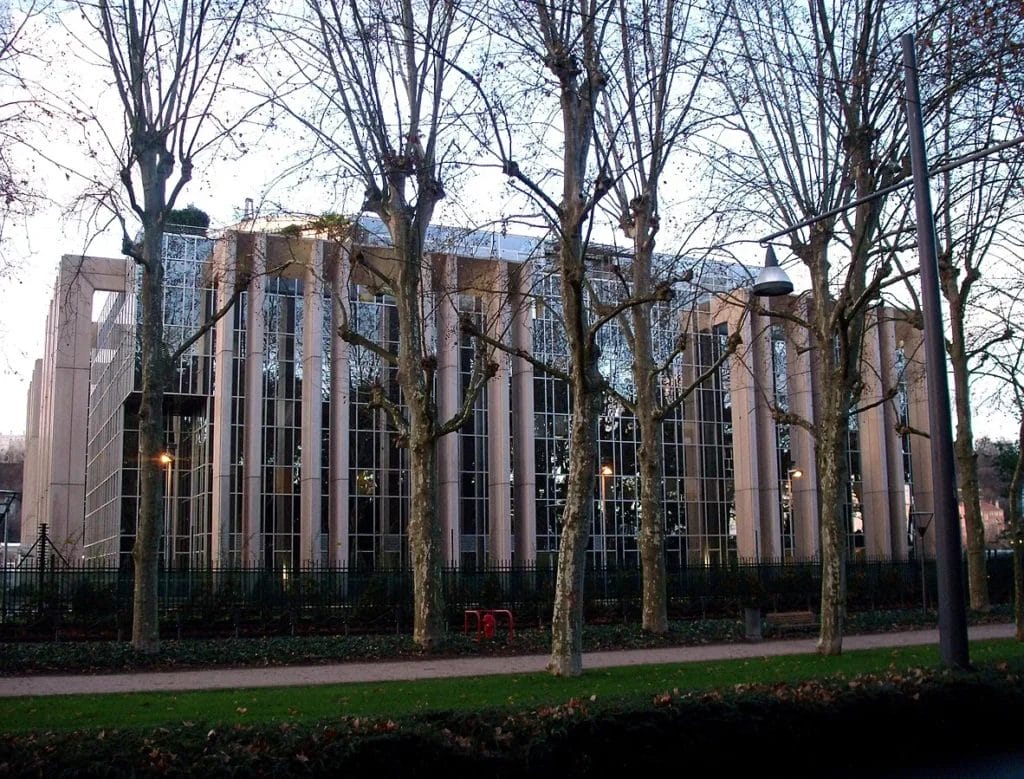 Exterior view of INTERPOL headquarters building in Lyon, photographed from the street level.