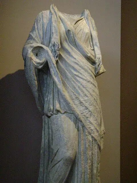 Roman marble identified as Isis or an Isiac priestess, evoking the cult that receives and reforms Lucius.