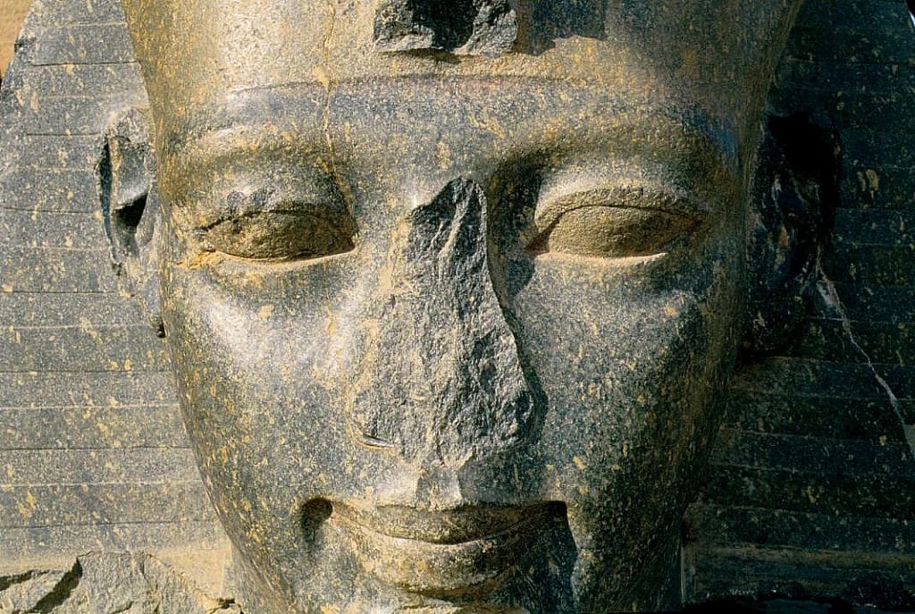 Granite head of Ramses II at the Ramesseum with the nose cut back close to the face.