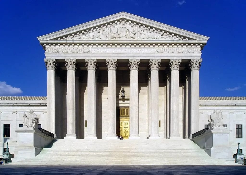Marble west facade of the U.S. Supreme Court with steps and Corinthian columns.
