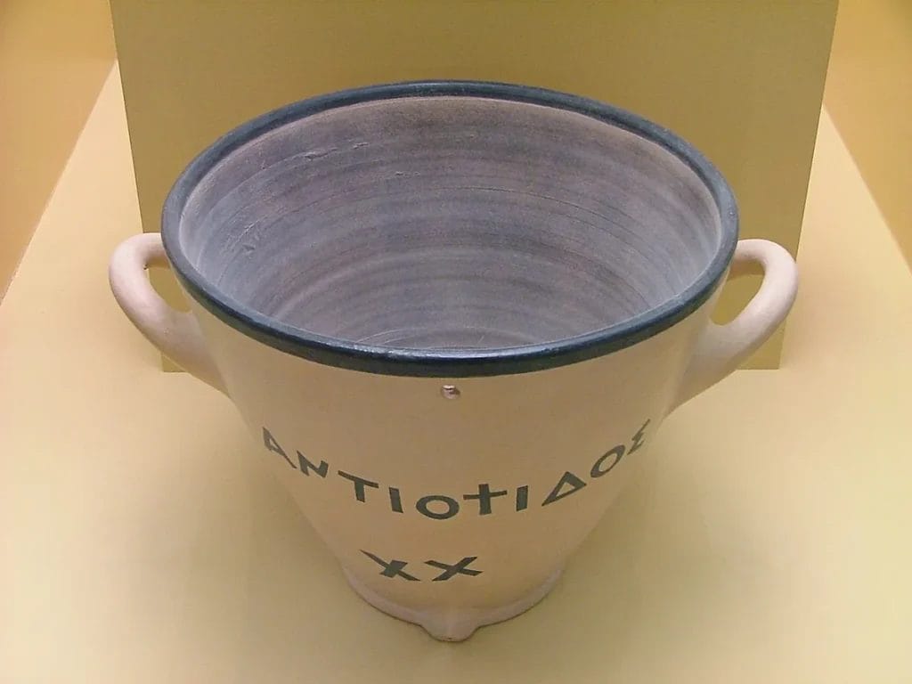 Clay reconstruction of a Greek water clock with measuring lines on the rim.