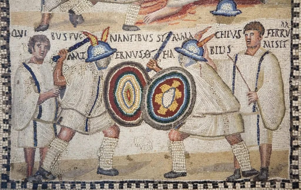 Third century Roman mosaic depicting gladiators Symmachus and Maternus fighting with trainers watching