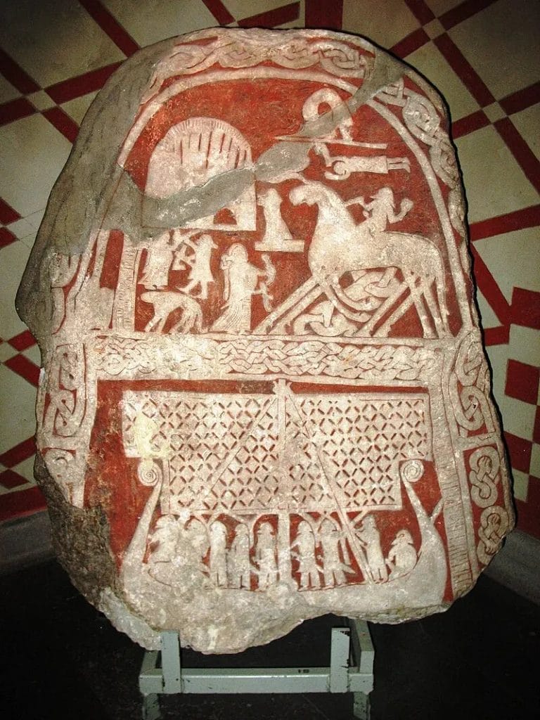 Viking Age limestone picture stone from Gotland showing a warrior on an eight-legged horse being greeted by a Valkyrie with a drinking horn at Valhalla