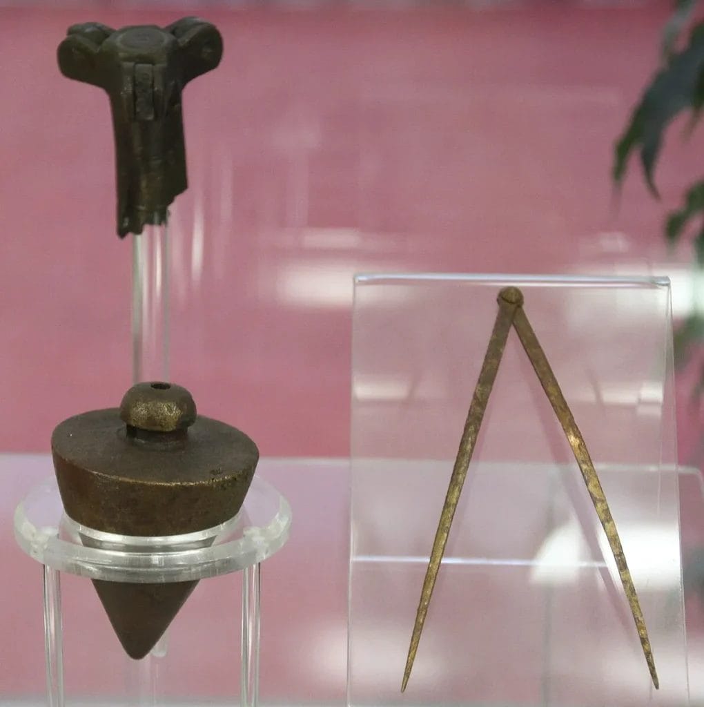 Display of Roman surveying tools including measuring equipment used by agrimensores for land division.