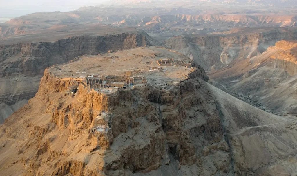 Aerial photograph of Masada fortress plateau rising above desert