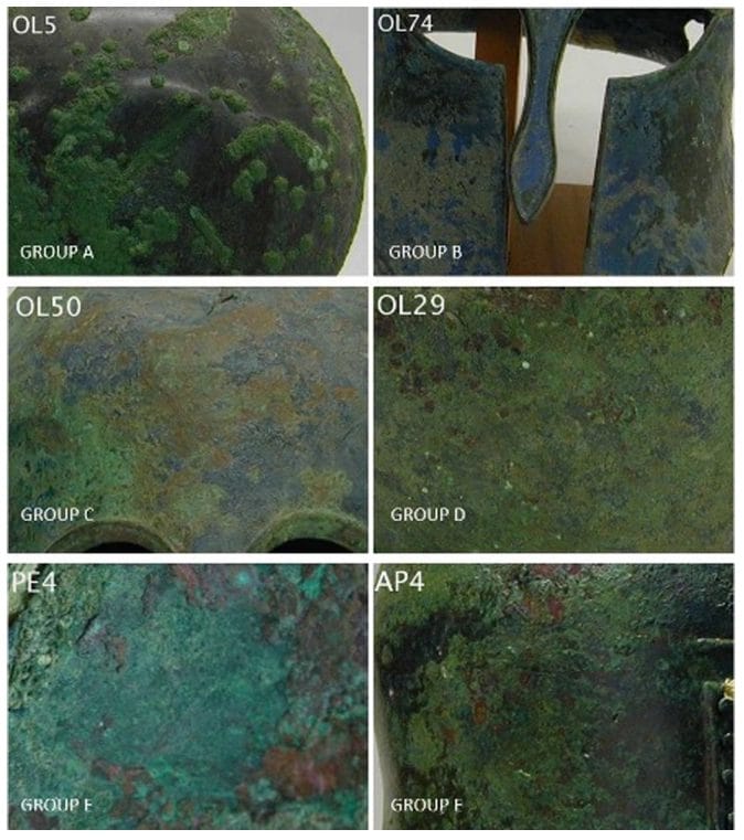 Six bronze corrosion samples showing green, blue, and brown patina layers from underwater archaeological helmets