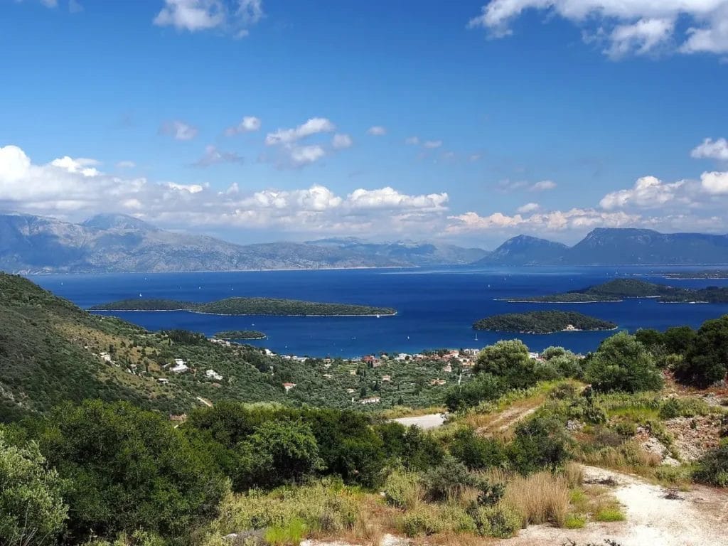 Turquoise Ionian Sea waters with rocky islands visible under clear Mediterranean sky near Lefkada Greece