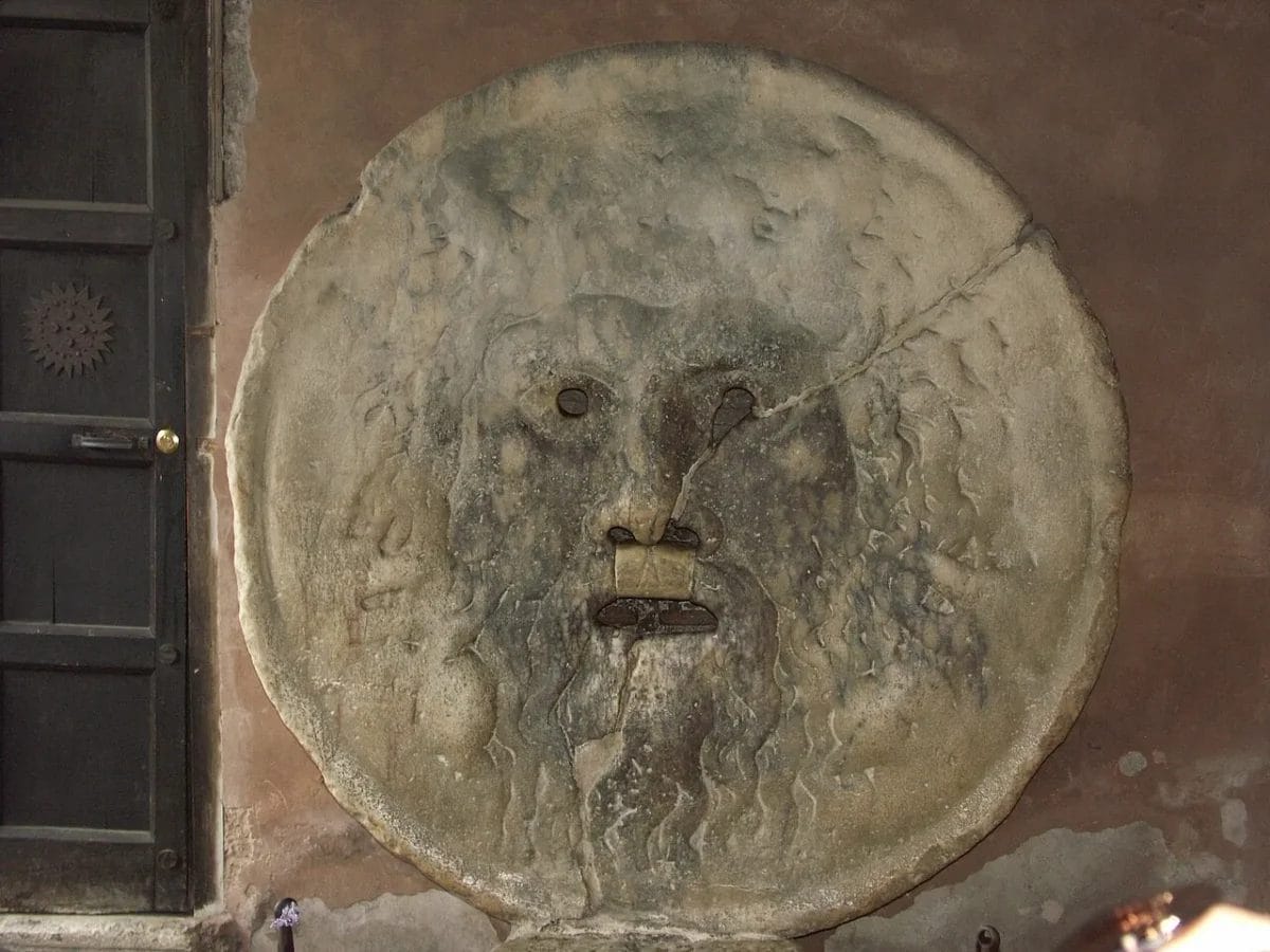 The Bocca della Verita ancient marble mask mounted on the wall of Santa Maria in Cosmedin in Rome, sights to see in Rome
