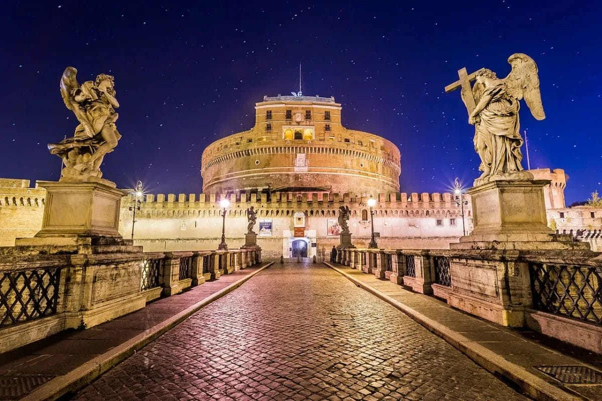 Castel Sant'Angelo in Rome viewed from Ponte Sant'Angelo showing the cylindrical Roman drum and bronze angel at the summit, sights to see in Rome