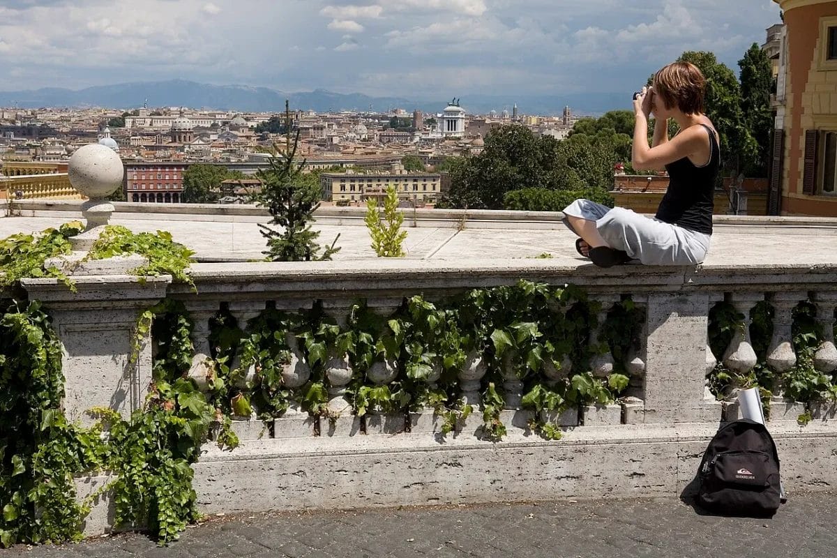 The view east over Rome from the Janiculum Hill summit showing the city skyline and dome of St. Peter's Basilica, sights to see in Rome