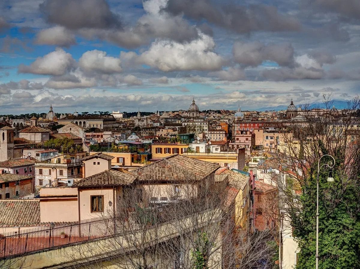 A narrow medieval street in Trastevere Rome with ochre buildings and cobblestones, sights to see in Rome
