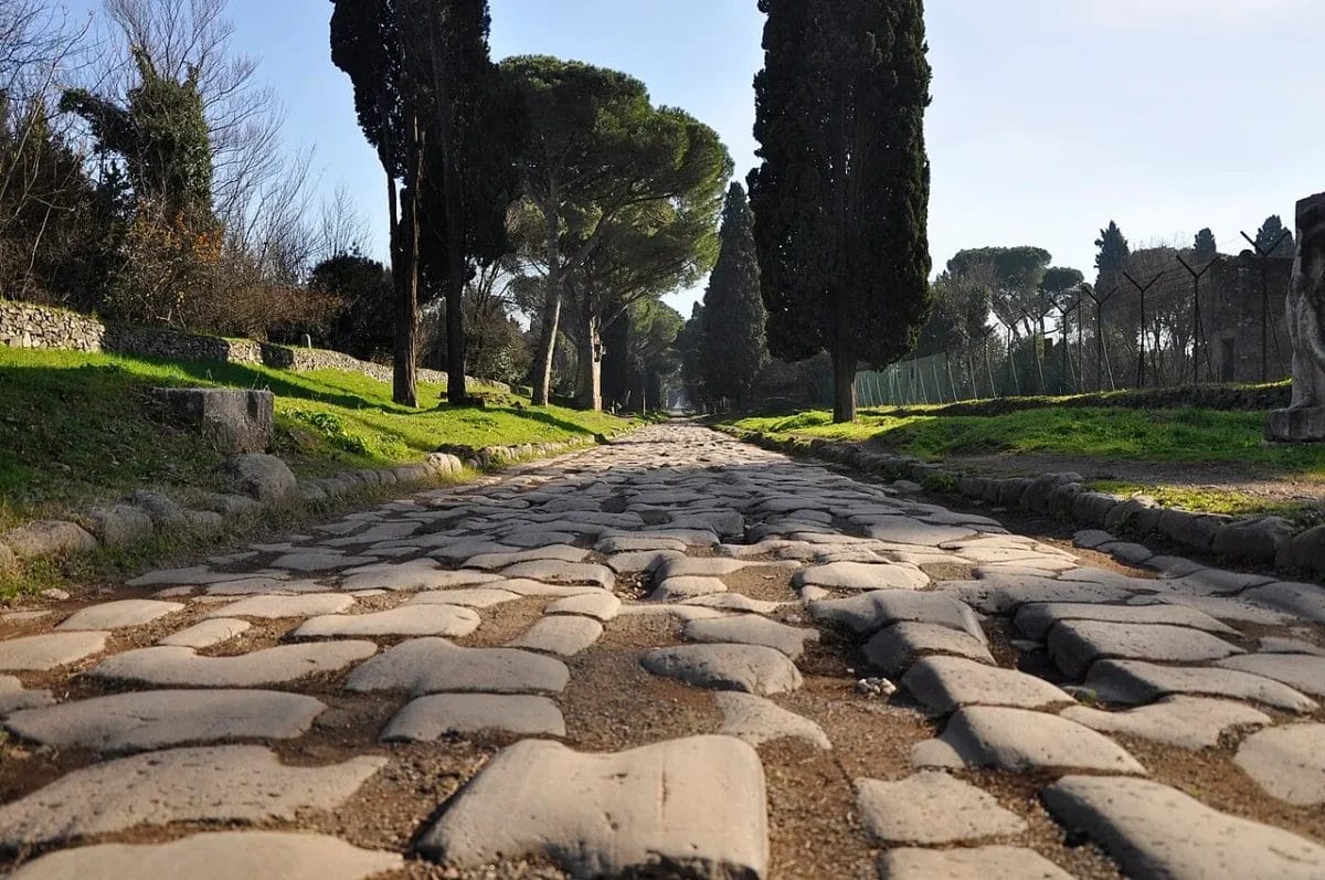 The original basalt stone surface of Via Appia Antica in Rome with cart ruts worn into the road by 2,000 years of traffic, sights to see in Rome