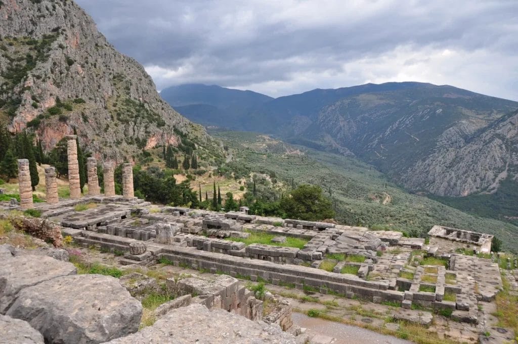 Temple of Apollo at Delphi with stone columns and sanctuary ruins on the slopes of Mount Parnassus