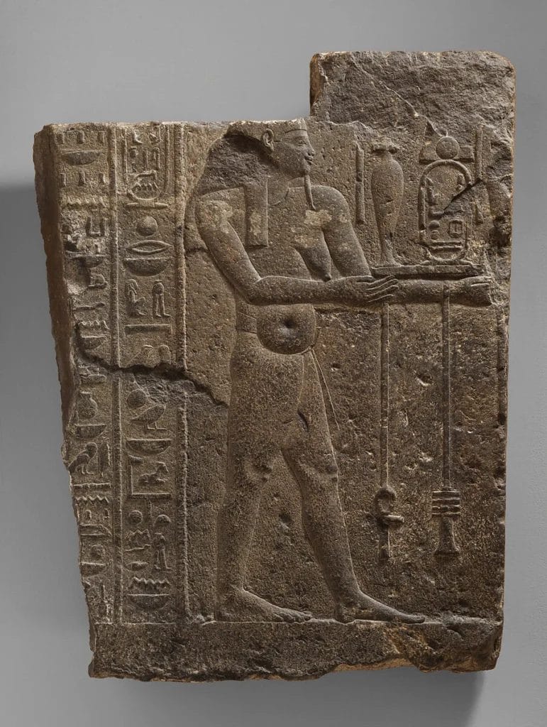 Egyptian fecundity figure representing fertility, growth, and birth behind the pregnancy grain test